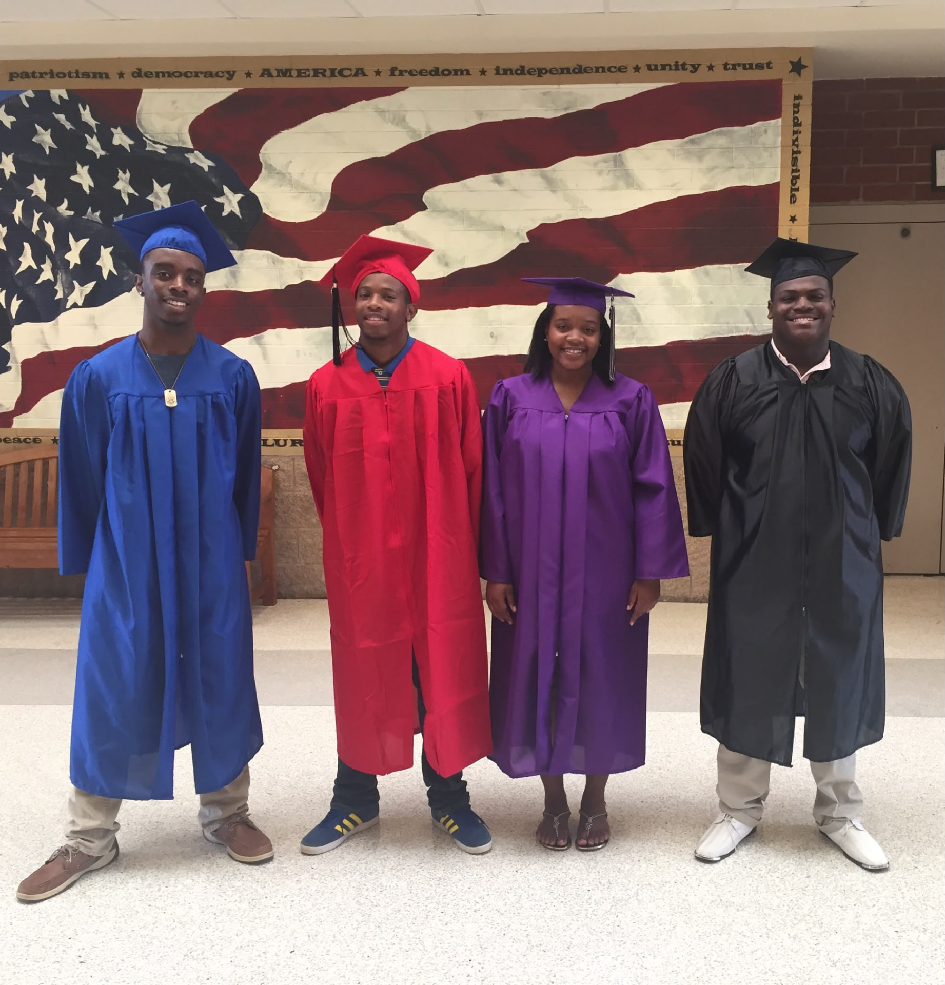 Kingdom Covenant Christian Church's first high school graduates in caps and gowns